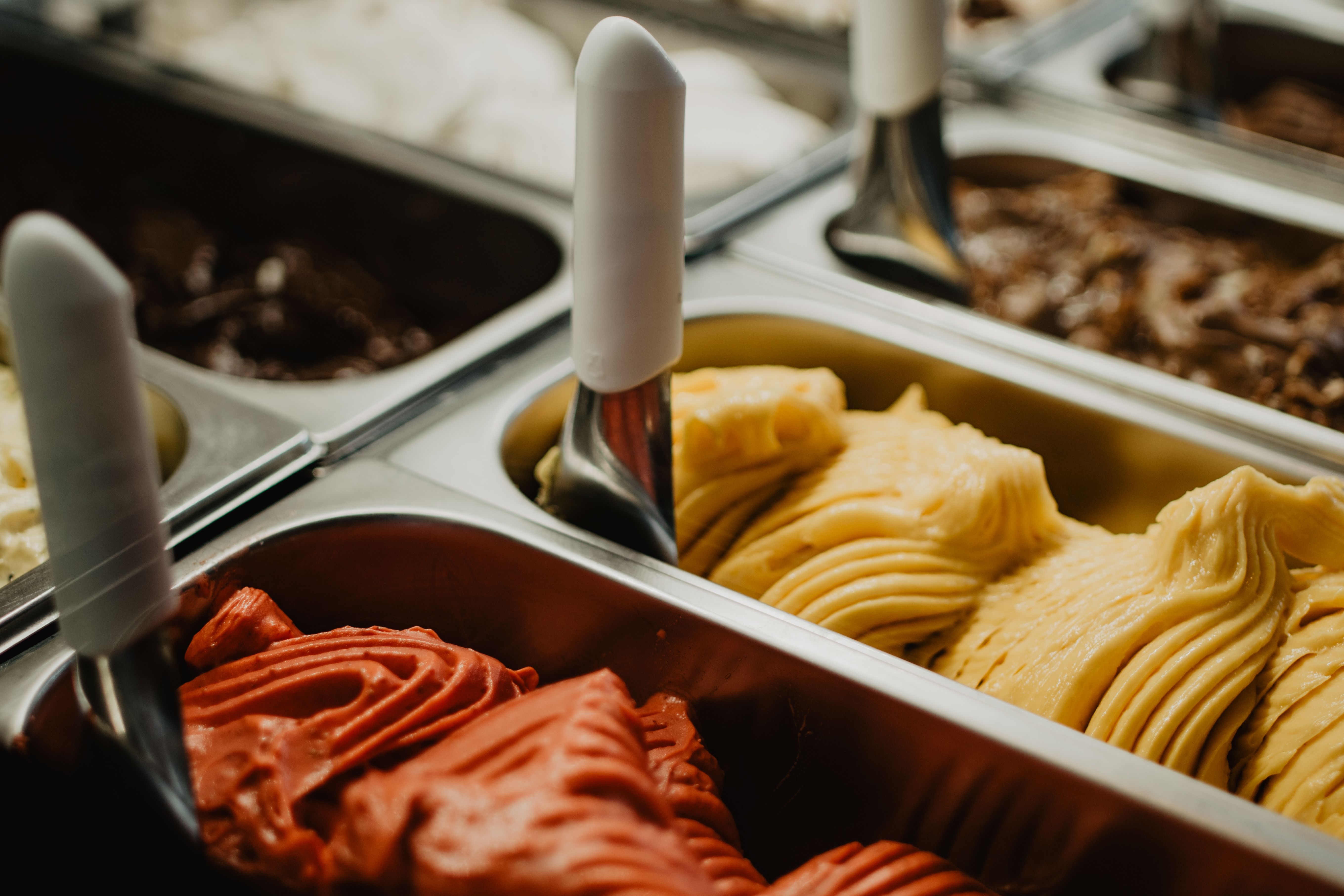 Rows of colorful flavors ready to be scooped onto a Wafflenis waffle